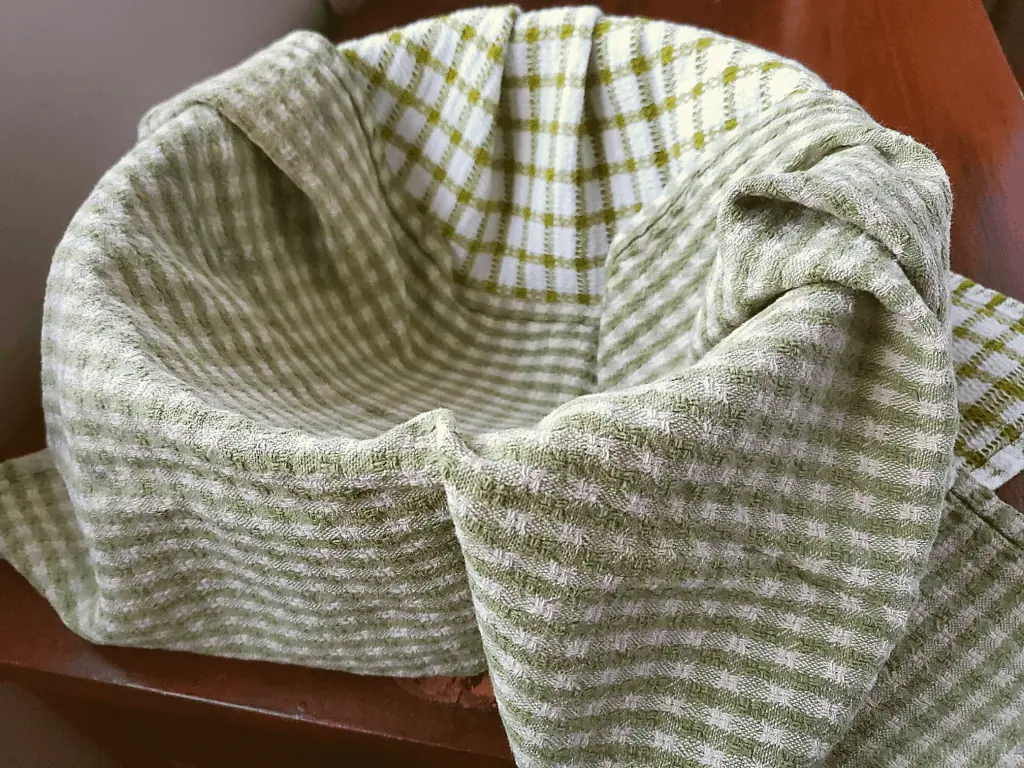 A bowl lined with 2 tea towels