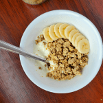 granola in a bowl with yogurt and bananas