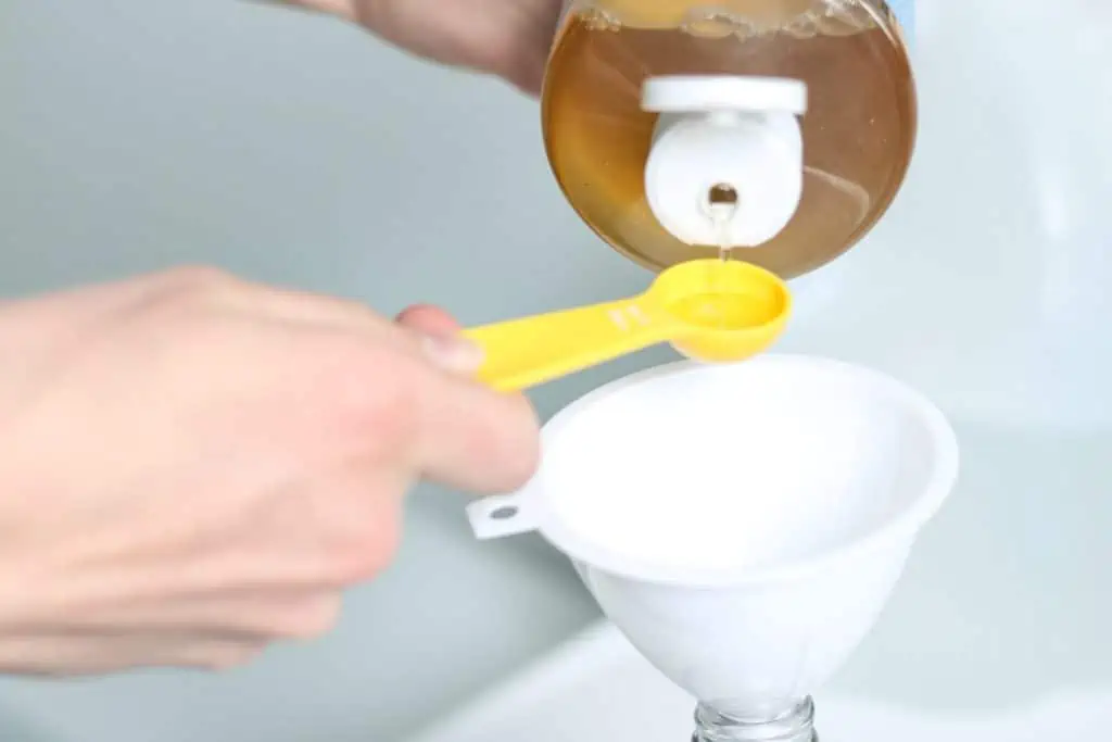 measuring castile soap for diy cleaner