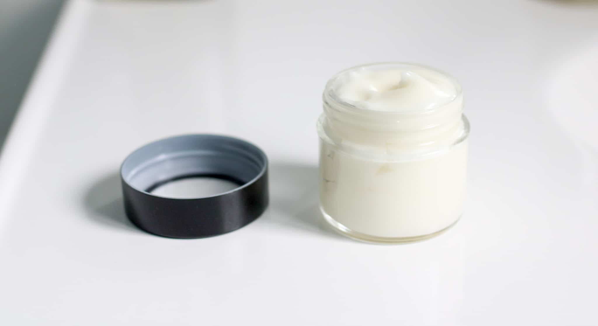 open jar of natural homemade face moisturizer on counter