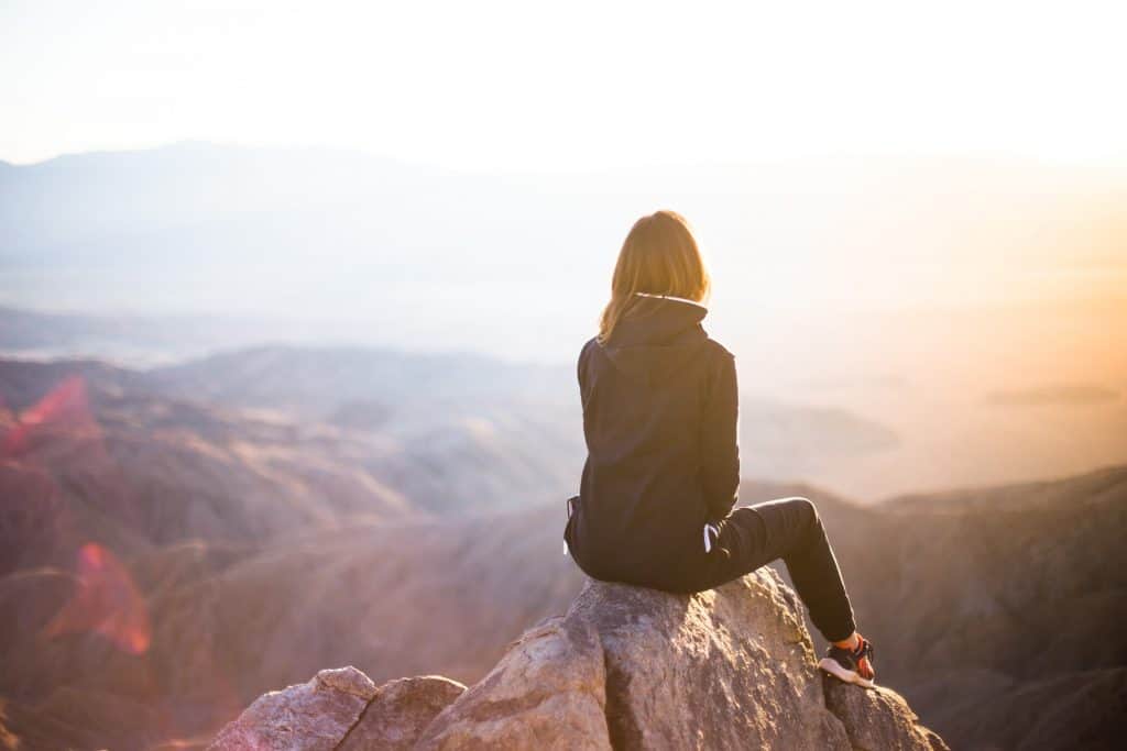 woman sitting on a mountain