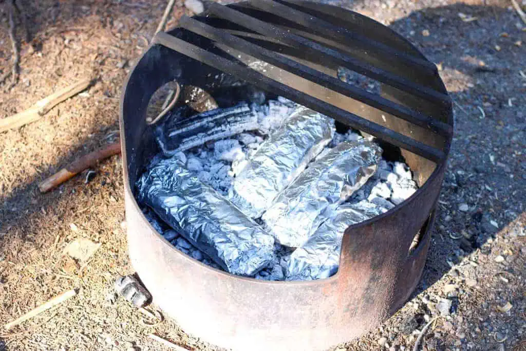 foil packet dinners cooking on hot coals