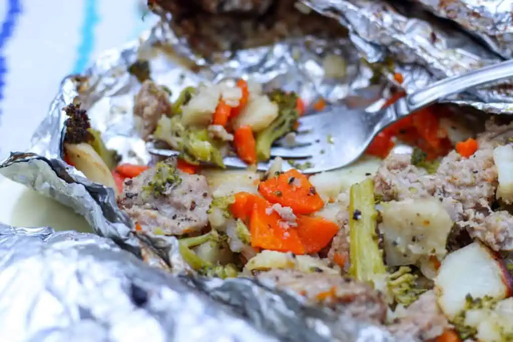 close up of veggies and sausage cooked in foil packet