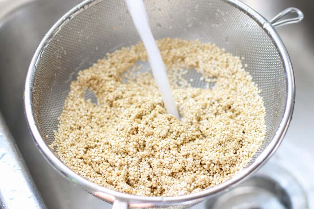 rinsing quinoa in a sieve