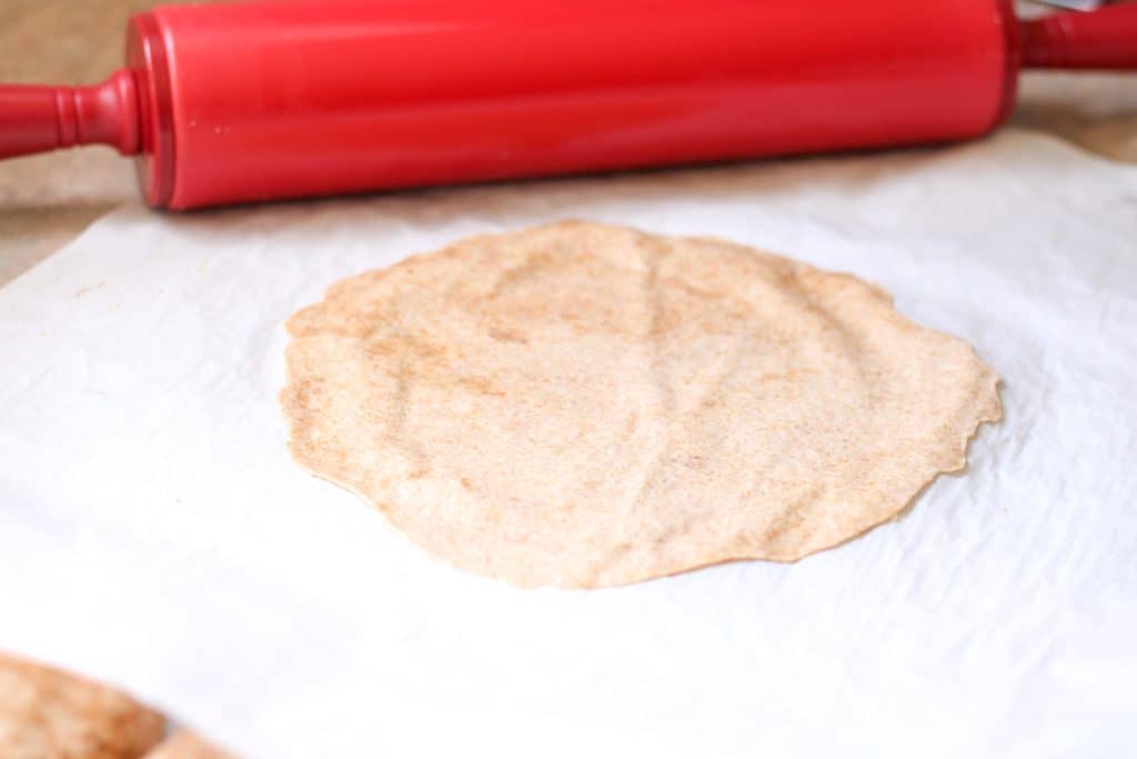 raw tortilla and rolling pin