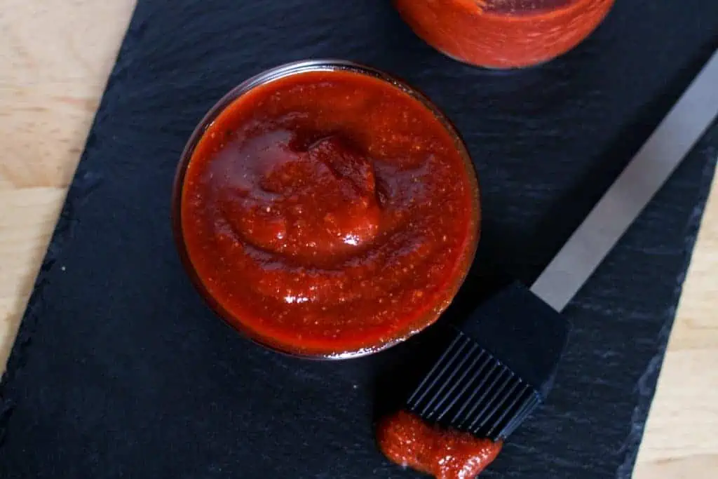 bowl of bbq sauce and brush