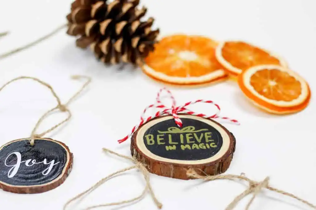 "Believe in Magic" tree cookie ornament with red and white bow