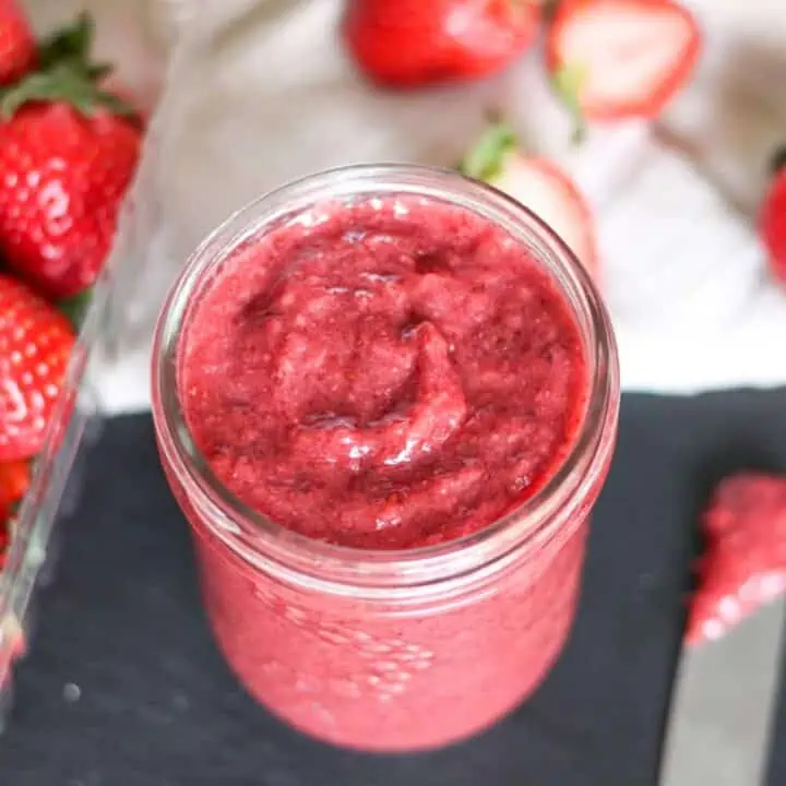 chia strawberry jam in a jar with strawberries