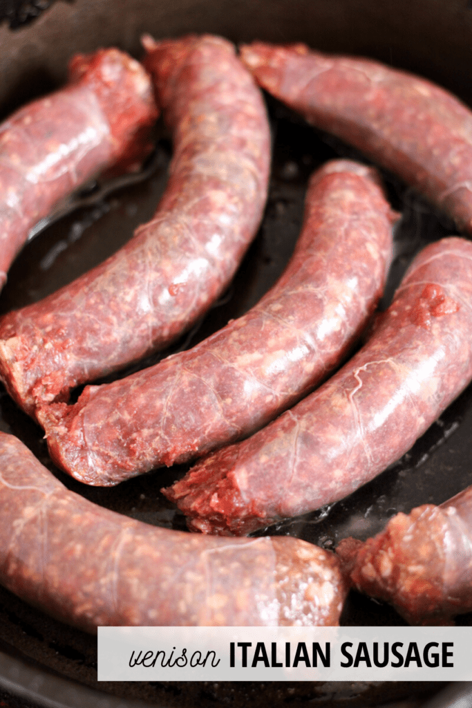 raw sausages in a cast iron skillet