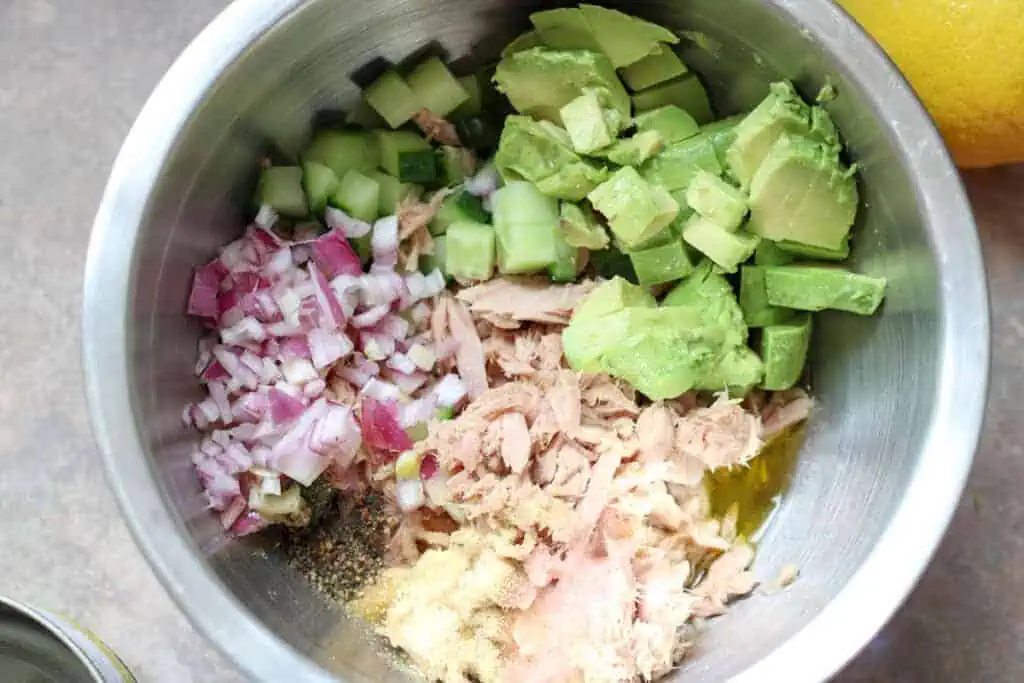 tuna, red onion, avocado, cucumber and seasonings in a mixing bowl