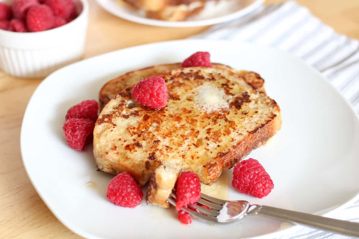 fork full of french toast and raspberry