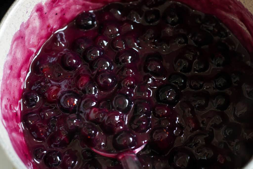 blueberry pie filling cooking in a saucepan