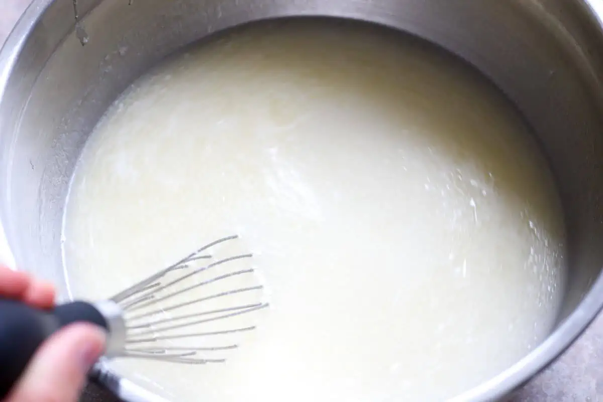 Whisking a white liquid in a bowl