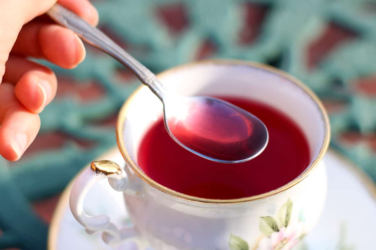 spoon of pink hibiscus tea