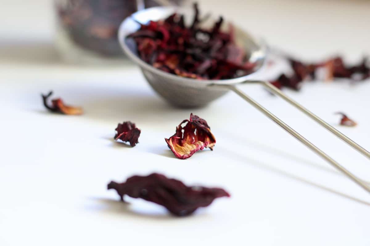 dried hibiscus petals on a white surface