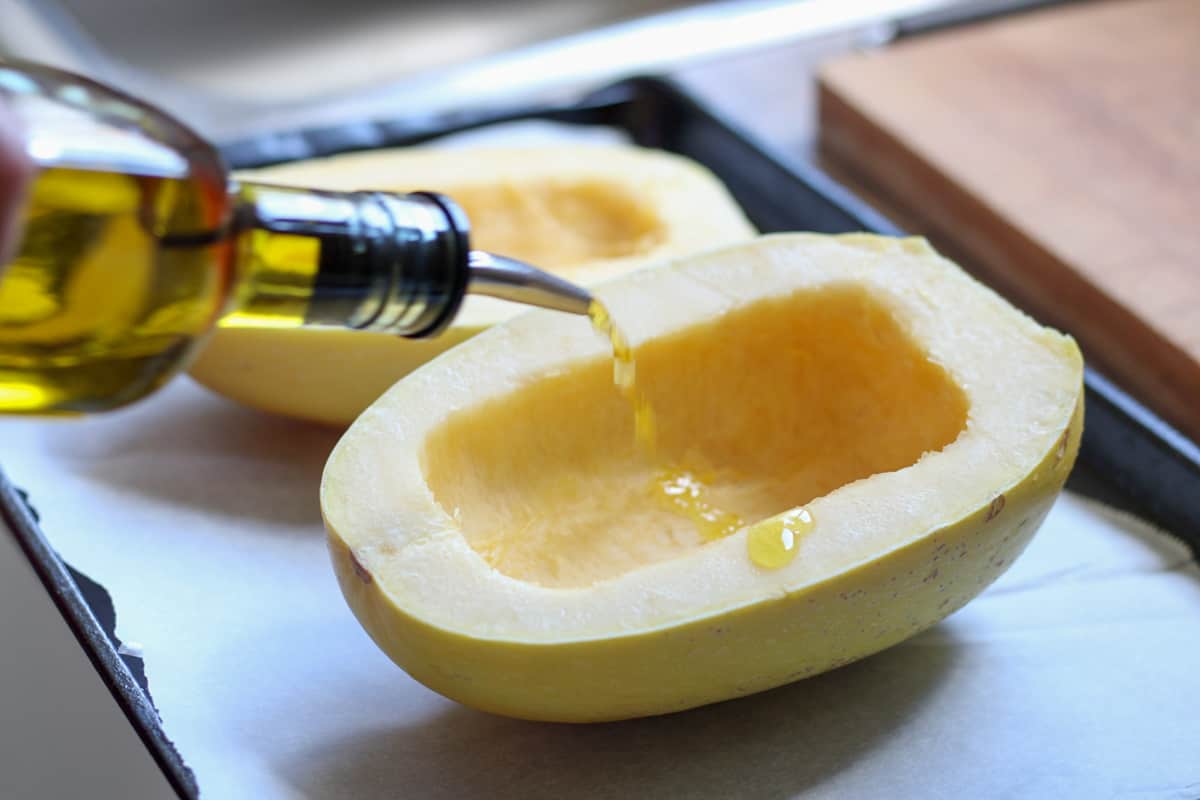 drizzling spaghetti squash with olive oil