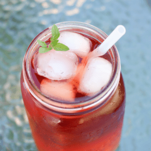 sun tea in a jar with ice cubes and straw