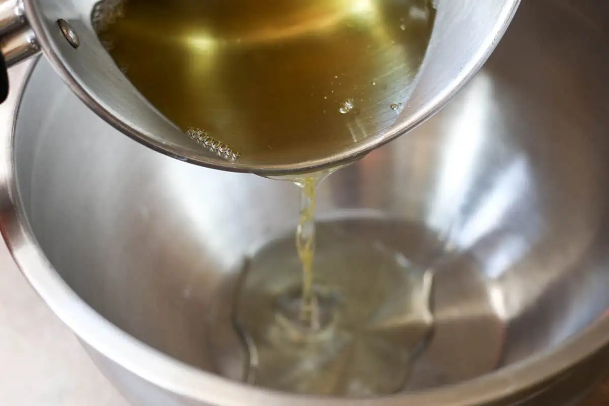 pouring melted tallow and oil into a bowl