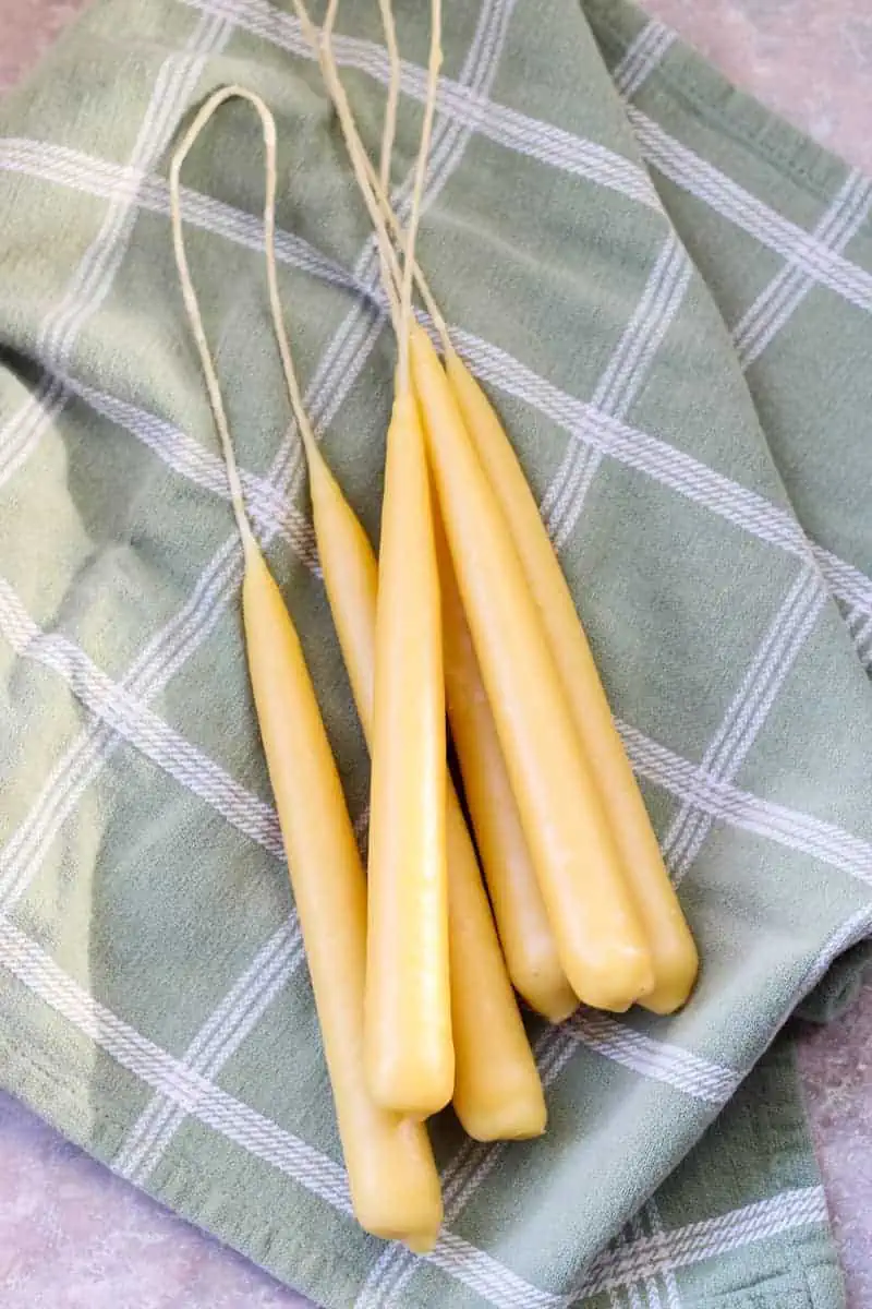 beeswax taper candles on a towel