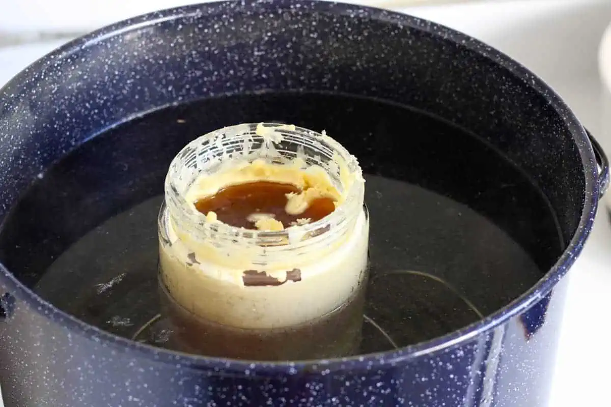 jar of wax melting in a large canning pot