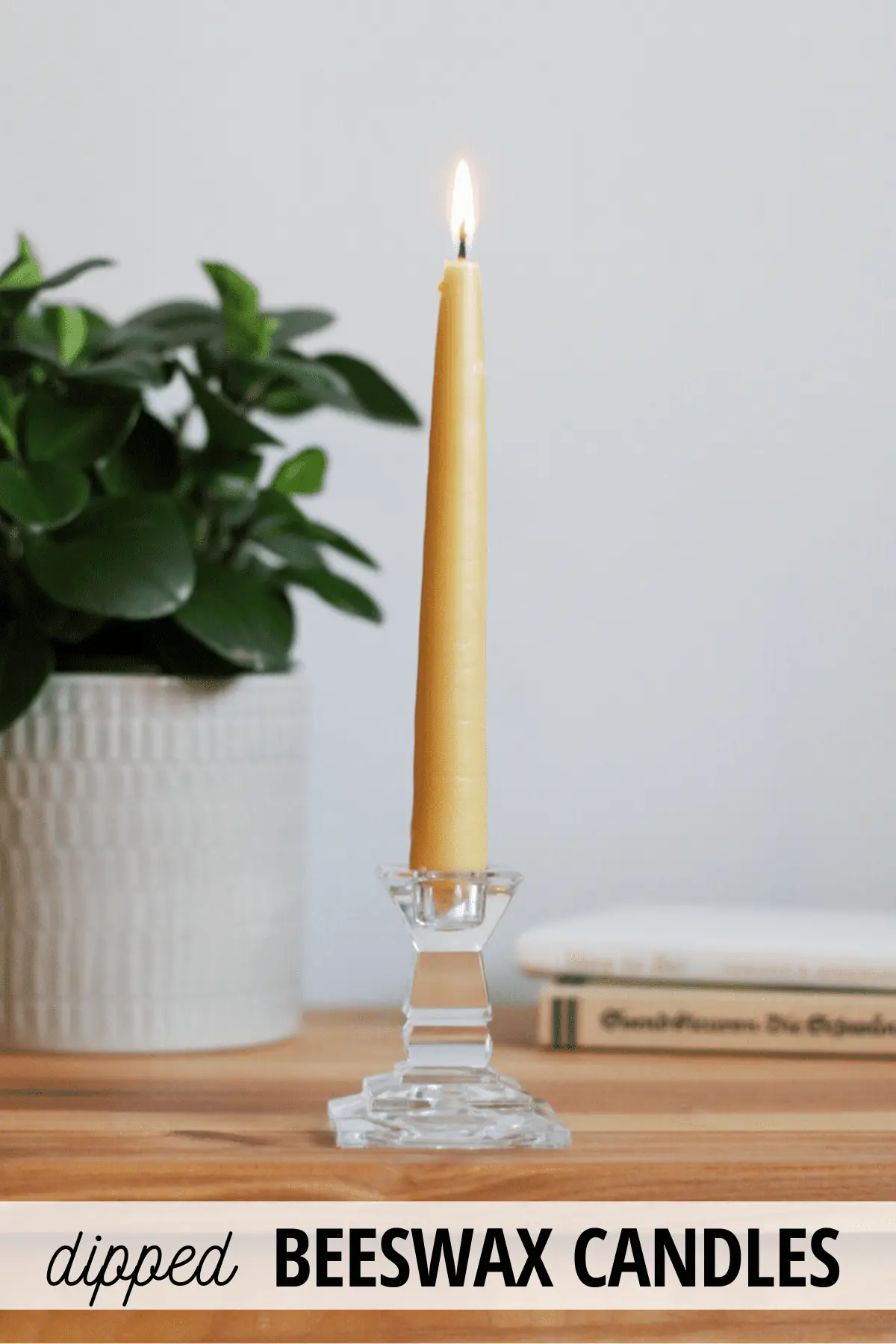 one burning beeswax taper candle
