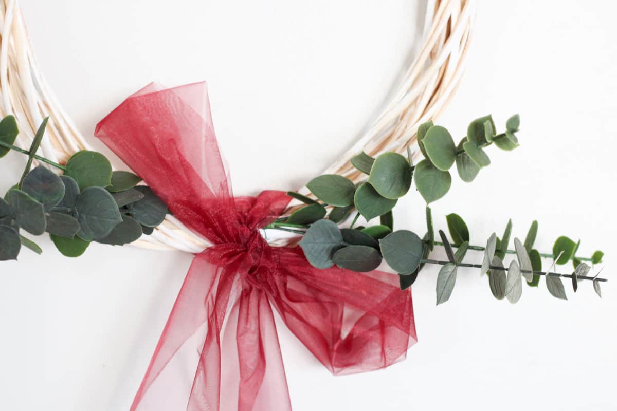 lower half of a wreath with eucalyptus and red bow