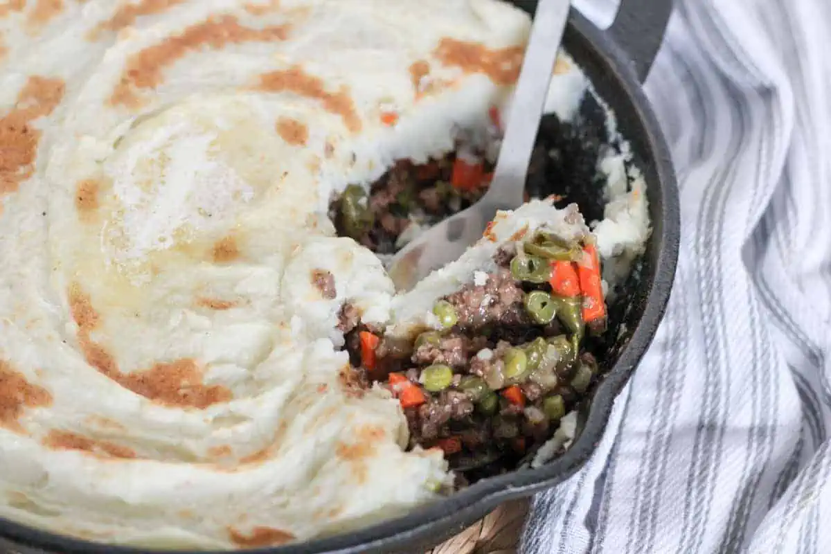 scopping shepherds pie out of a skillet
