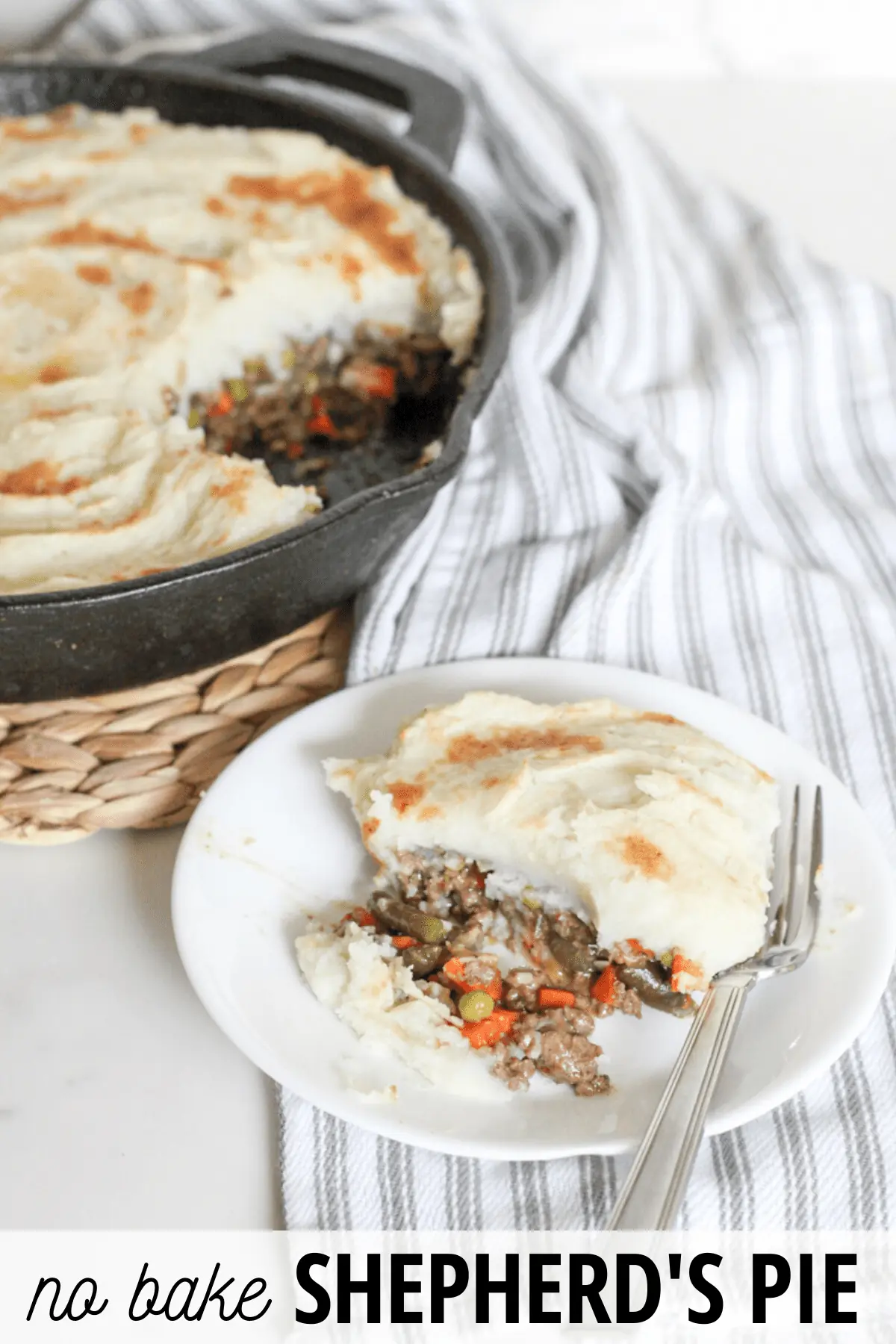 plate of shepherds pie with cast iron pan in the background
