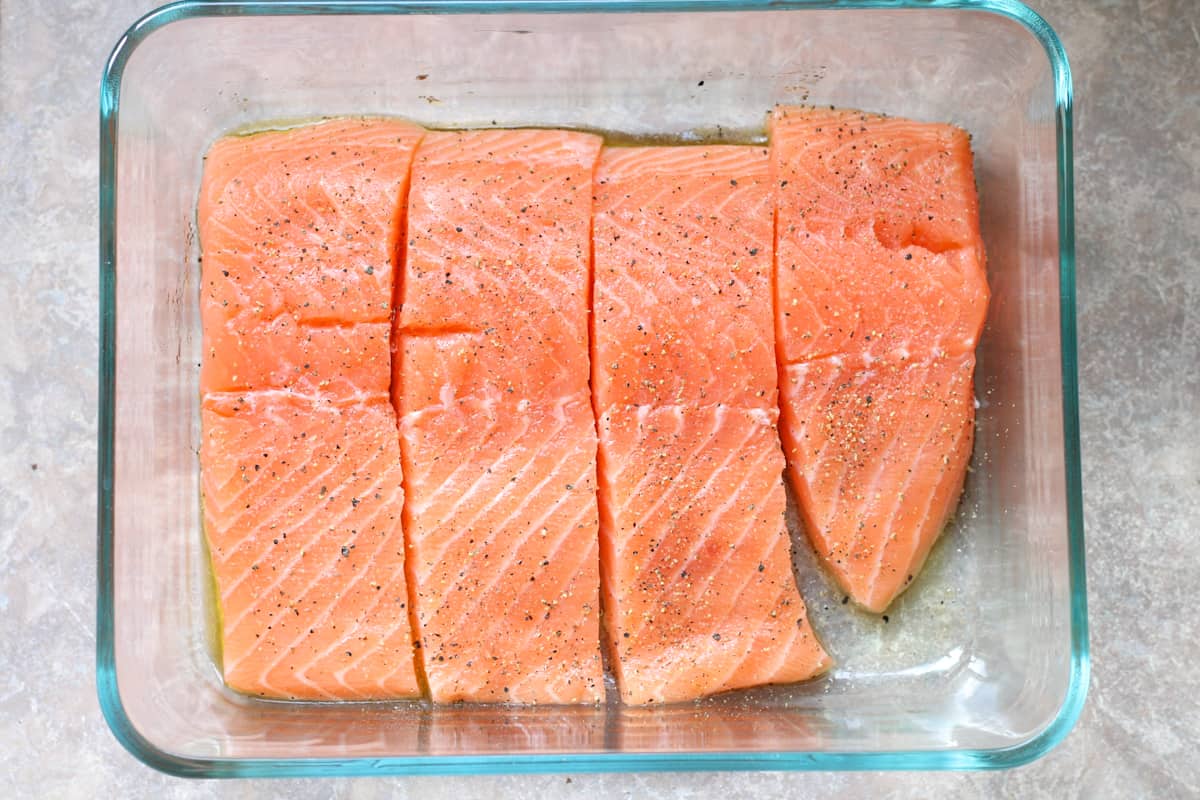 4 salmon fillets in a glass baking dish