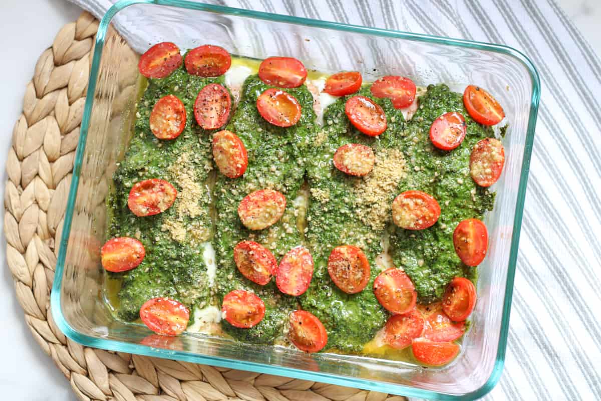 baked pesto salmon in a dish on a towel