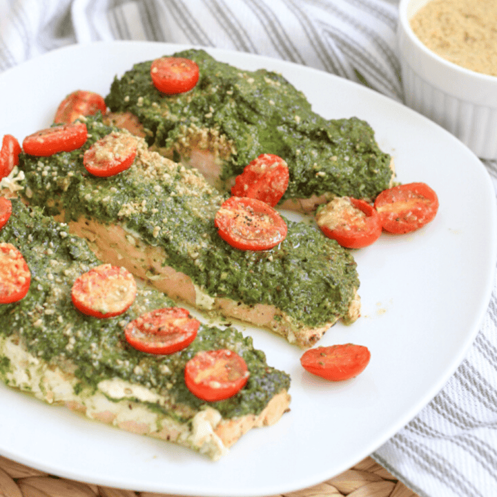plate with pesto salmon fillets on it