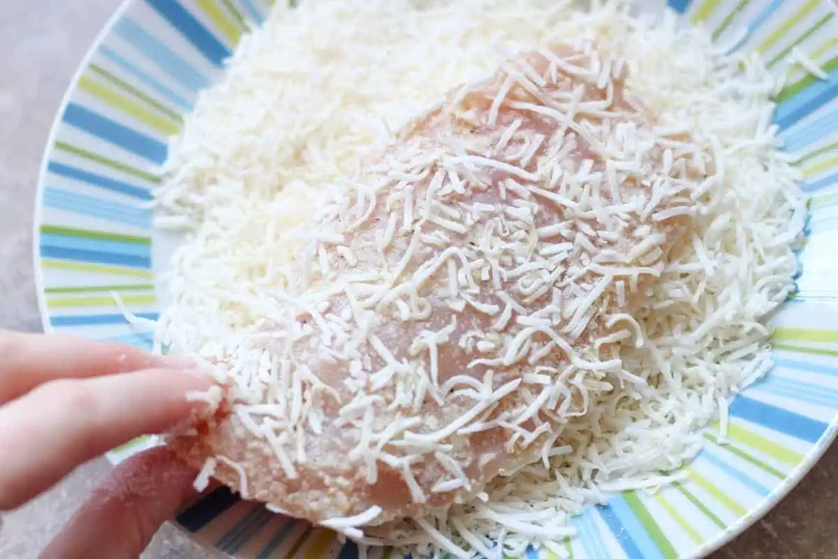 coating a chicken breast with shredded coconut