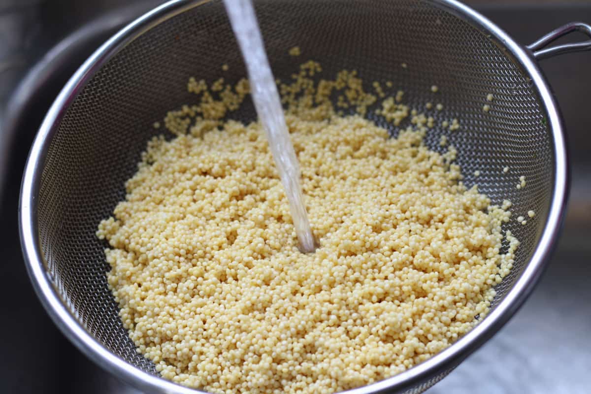 rinsing millet out in a sieve