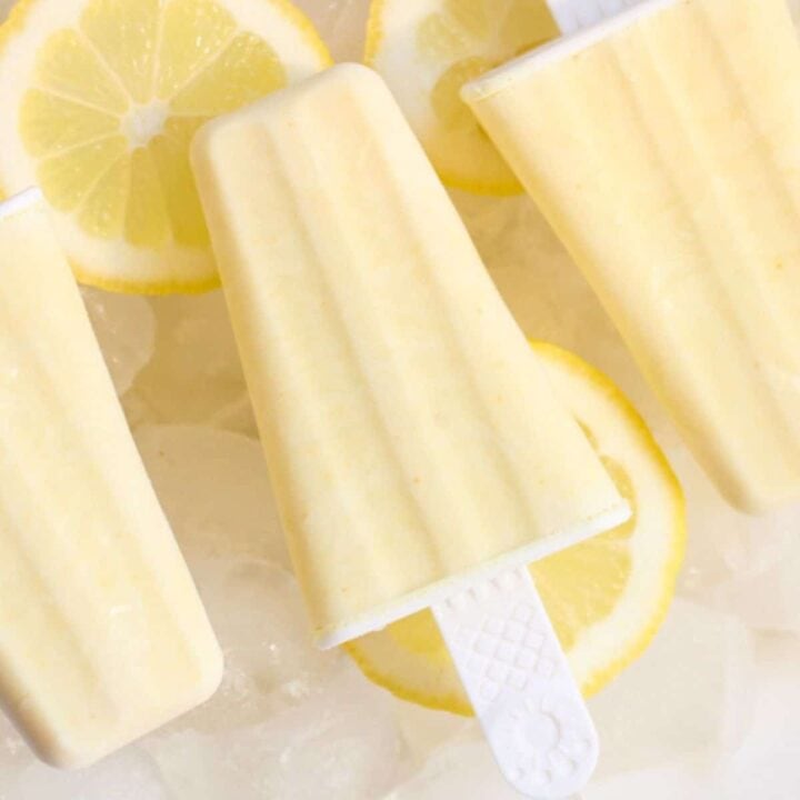 yellow lemon popsicle on lemon slices and ice