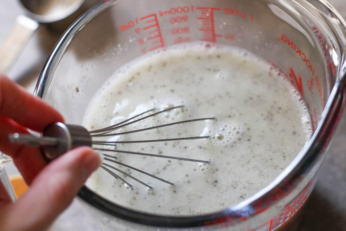 whisking wet ingredients in a liquid measuring cup