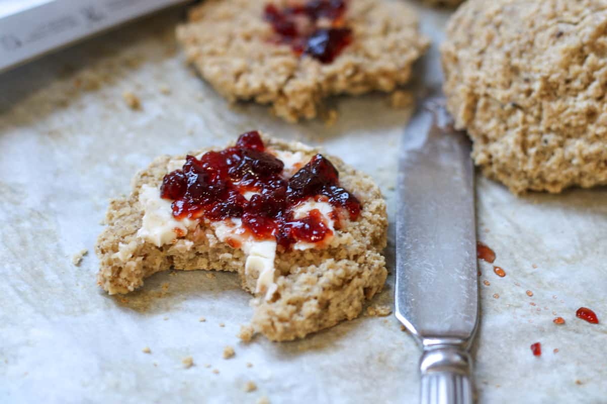 biscuit with jam and butter beside butter knife