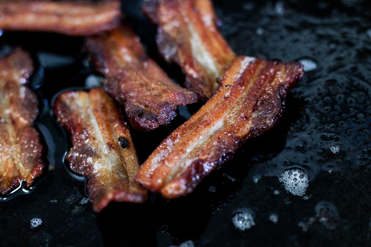 bacon frying in a pan
