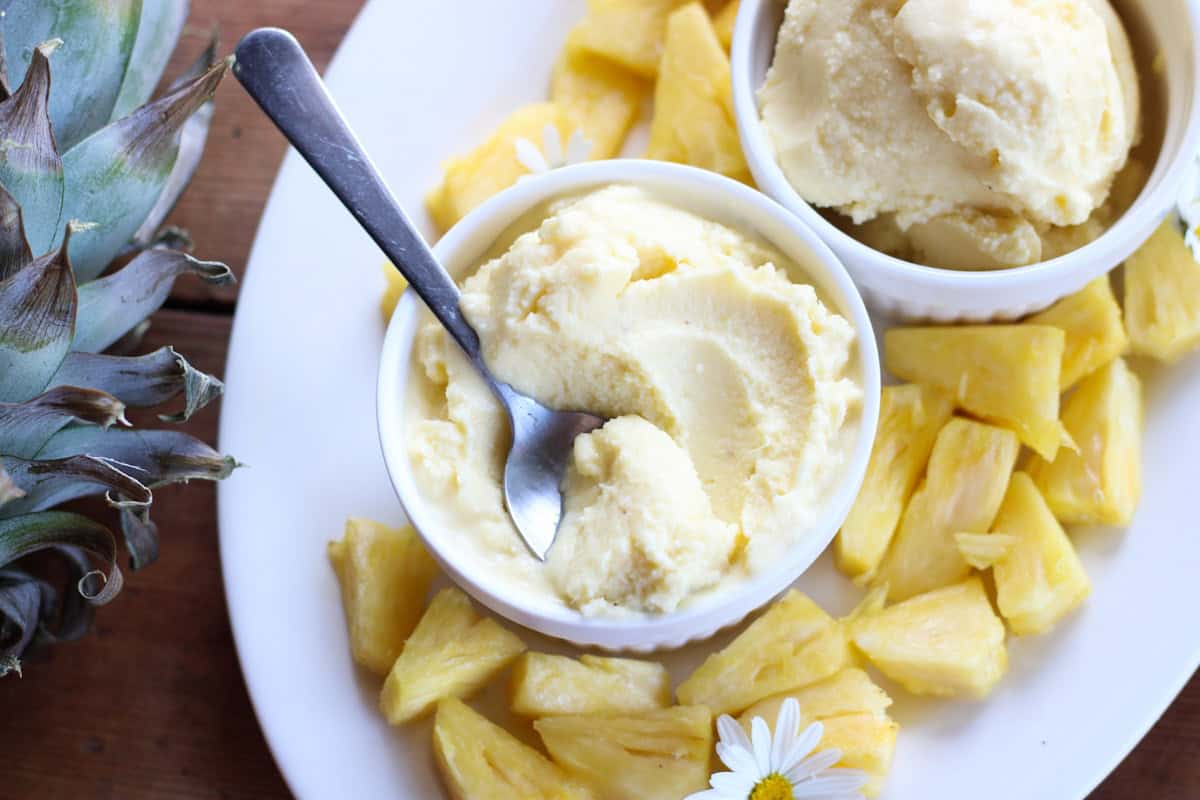 spoon in bowl of pineapple ice cream